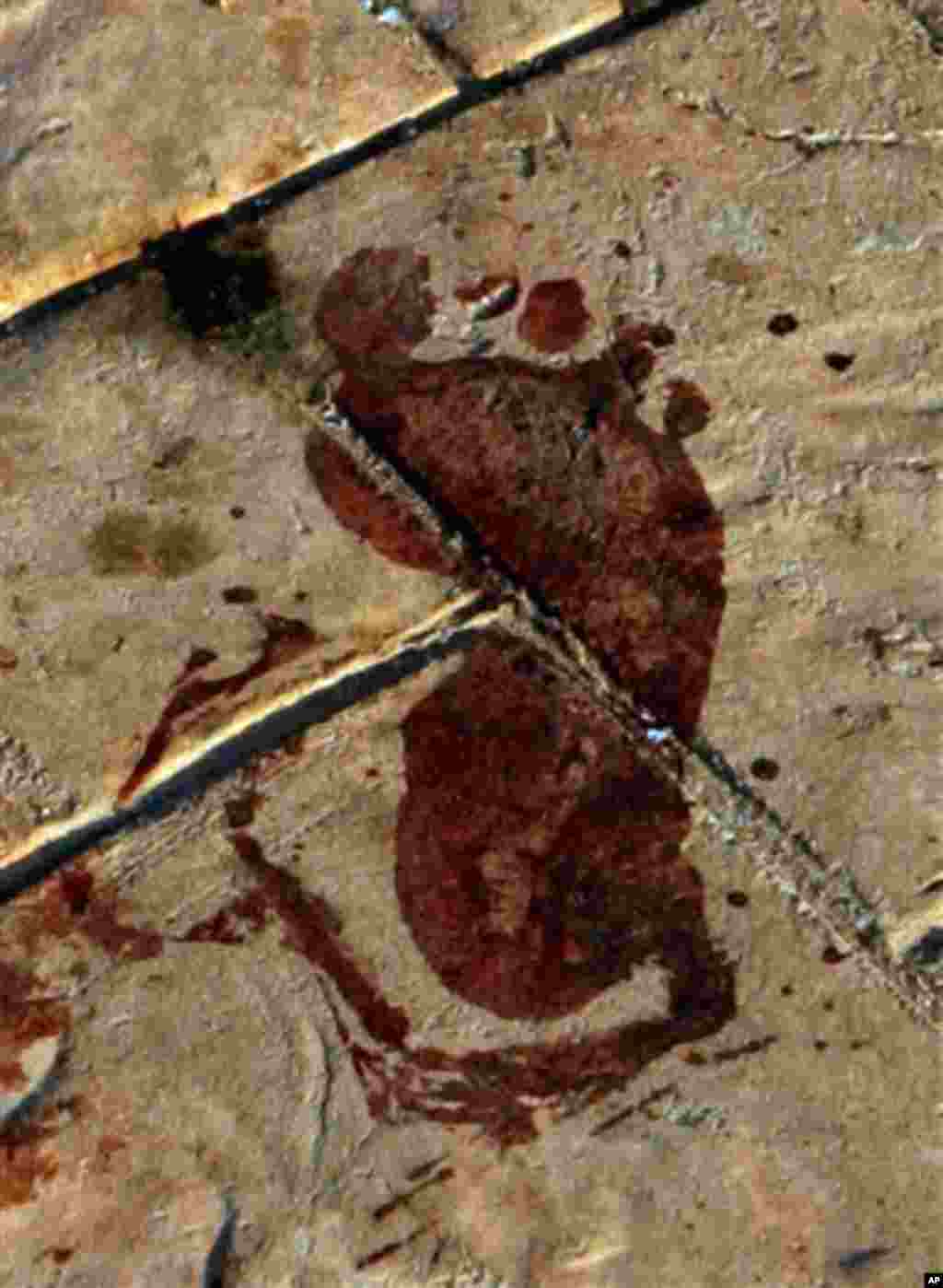 A bloodied foot print is seen in this April 25, 2006, file photo, at the site where one of three bombs ripped through Egypt's Red Sea resort of Dahab. Shards of glass and bloody body parts littered the ground as Egypt reeled from a three-bomb attack that ripped apart a Sinai beach resort promenade at the height of Egypt's tourist season, killing at least 24 people, including a German child. More than 60 others were hurt.
