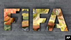 FILE - The FIFA logo is fixed on a wall of the FIFA headquarters in Zurich, Switzerland.