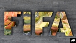 FILE - The FIFA logo on a wall of the FIFA headquarters in Zurich, Switzerland, Sept. 25, 2015. FIFA admitted on March 16, 2016, its executive committee members sold past World Cup votes as it seeks to claim tens of millions of dollars in bribe money seized by U.S. officials.