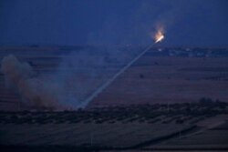 Turkish forces fire rockets toward targets in Ras al-Ayn, Syria, Oct. 15, 2019.