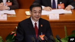 FILE - China's Chief Justice Zhou Qiang delivers a speech during a plenary session of the National People's Congress at the Great Hall of the People in Beijing, March 12, 2017. 