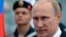 FILE - Russian President Vladimir Putin heads to speak at a navy parade marking Victory Day in Sevastopol, Crimea, May 9, 2014.