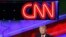 FILE - Then-presidential candidate Donald Trump is pictured beneath the CNN logo at a Republican candidates debate, sponsored in part by the cable news organization, at the University of Miami, March 10, 2016, in Coral Gables, Fla. 