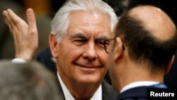 U.S. Secretary of State Rex Tillerson speaks with a delegate during the afternoon ministerial plenary for the Global Coalition working to Defeat ISIS at the State Department in Washington, March 22, 2017. 