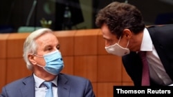 EU chief Brexit negotiator Michel Barnier speaks with France's Permanent Representative to the EU Philippe Leglise-Costa during a meeting of ambassadors of European Union governments in Brussels, Belgium Dec. 7, 2020.