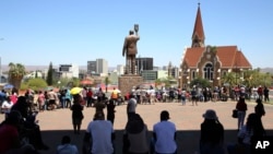 FILE - Namibians line to vote in Windhoek, Namibia, Nov. 27, 2024. On Friday, three judges on the country’s Electoral Court ruled two political parties can examine Electoral Commission materials from last month’s presidential and legislative elections. 