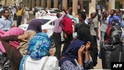 FILE - Sudanese protesters take part in an anti-government demonstration in Khartoum, Feb. 14, 2019. 