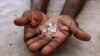 An illegal diamond dealer from Zimbabwe displays diamonds for sale in Manica, near the border with Zimbabwe. (File Photo)