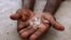 An illegal diamond dealer from Zimbabwe displays diamonds for sale in Manica, near the border with Zimbabwe. (File Photo)