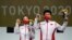Gold medalists Jiang Ranxin, and Pang Wei, of China, celebrate after the mixed team 10-meter air pistol at the Asaka Shooting Range in the 2020 Summer Olympics, July 27, 2021, in Tokyo, Japan.