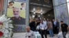 Ljudi napuštaju džamiju u dominantno iračkom južnom kraju Teherana, Iran, 30. jula 2019. Na zidu se vidi poster sa likom generala Qassema Soleimanija, zajedno sa vrhovnim liderom Ali Hameneijem i ajatolahom Homeinijem.