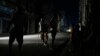 A man walks along a street with the aid of crutches during a massive blackout after a major power plant failed in Havana, Oct. 18, 2024.