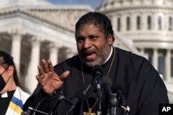 FILE - The Rev. William Barber and the Poor People's Campaign talks to reporters about voting rights, health care, immigrant rights and action on climate change, during a news conference on Capitol Hill in Washington, October 27, 2021