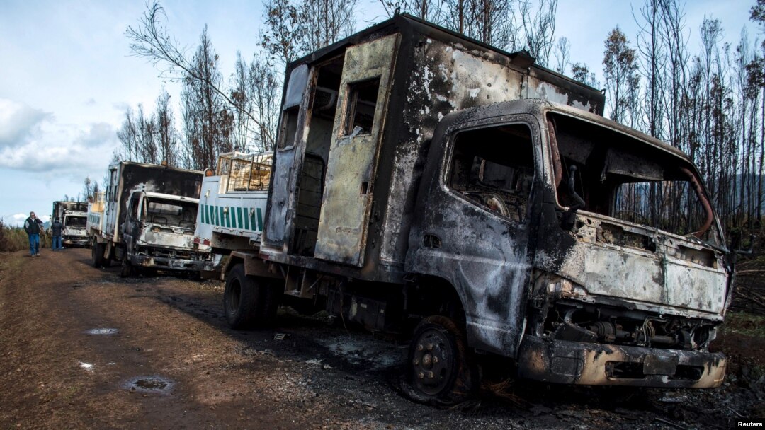 Burnt-out trucks are pictured on a rural road near Angol town, Temuco city, south of Santiago, Chile Aug. 7, 2015. Six trucks and heavy machinery of a forest company were burned in an arson attack in a rural area on the road between Angol and Collipulli