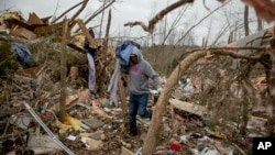 Danny Allen helps recover belongings while sifting through the debris of a friend's home destroyed by a tornado in Beauregard, Alabama, March 4, 2019. 
