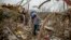 Danny Allen helps recover belongings while sifting through the debris of a friend's home destroyed by a tornado in Beauregard, Alabama, March 4, 2019. 