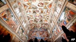Visitors admire the Sistine Chapel of the Vatican Museums as the museum reopens, in Rome, Italy, May 3, 2021.