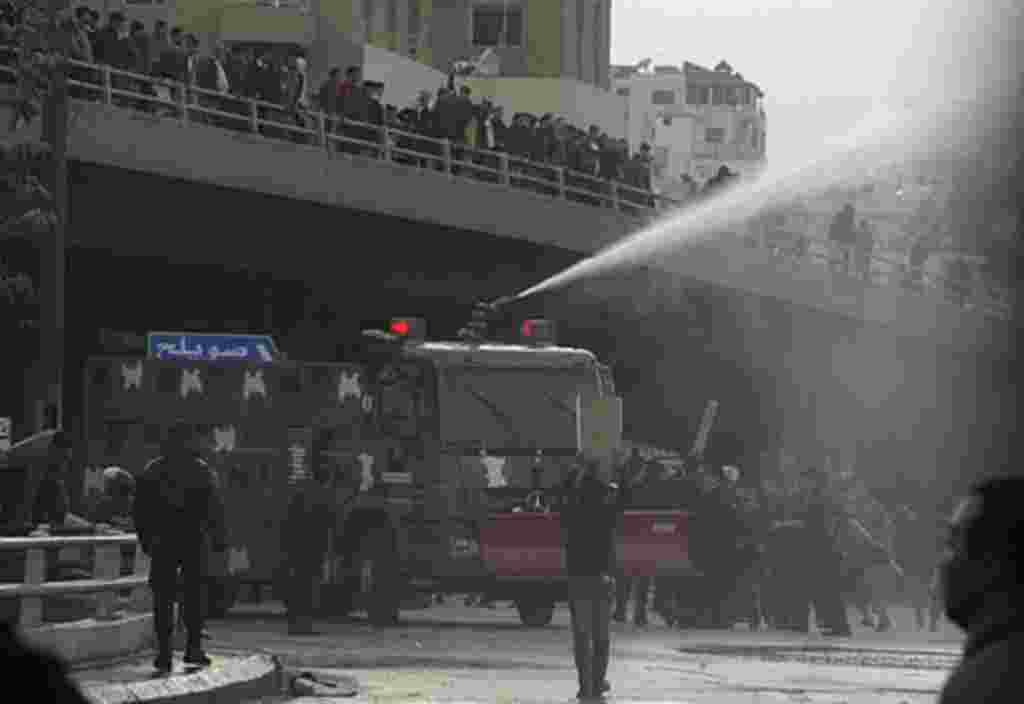 Protesters calling themselves the "Youth of March 24 Movement" demonstrate to demand for political reform and the ouster of the prime minister in front of police water canons at a main square in Amman, March 25, 2011