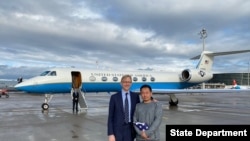 Chinese American academic Xiyue Wang, released by Iran after three years in jail as part of a prisoner swap with the U.S., stands with U.S. Special Representative for Iran Brian Hook at Zurich airport on December 7, 2019.