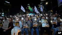 Citizens stage a rally against deepfake sex crimes in Seoul, South Korea, Sept. 27, 2024. The banners read 'You can't insult us.'