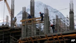 In preparation for the 2014 Winter Games at the Black Sea resort of Sochi, a hotel is under construction in nearby Krasnaya Polyana, Russia, Feb. 4, 2013.