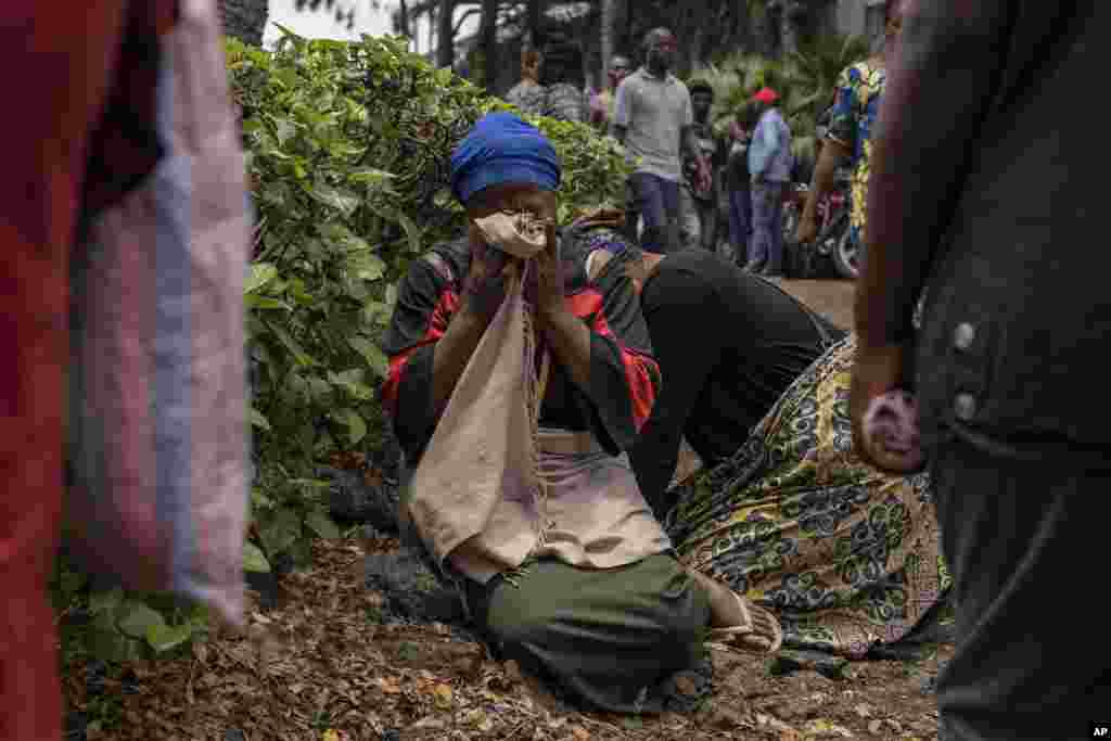 Women grieve at the port of Goma, Democratic Republic of Congo, after a ferry carrying hundreds capsized on arrival.