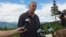 FILE - Interior Secretary Ryan Zinke talks with reporters with part of Mount Katahdin in the background at the Katahdin Woods and Waters National Monument near Staceyville, Maine, June 14, 2017.
