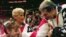 FILE - In this July 23, 1996, photo, Bela Karolyi, right, congratulates Dominique Moceanu, left, after the United States captured the gold medal in the women's team gymnastics competition at the Summer Olympic Games in Atlanta. U.S. team coach Martha Karolyi looks on. 