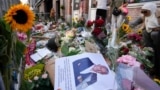 Journalist Peter R. De Vries' picture and flowers mark the spot where he was shot two days prior, in Amsterdam, Netherlands, July 8, 2021. De Vries was widely lauded for fearless reporting on the Dutch underworld.