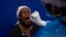 A patient gets a throat swab to test for COVID-19 at a facility in Soweto, South Africa, Dec. 2, 2021. 