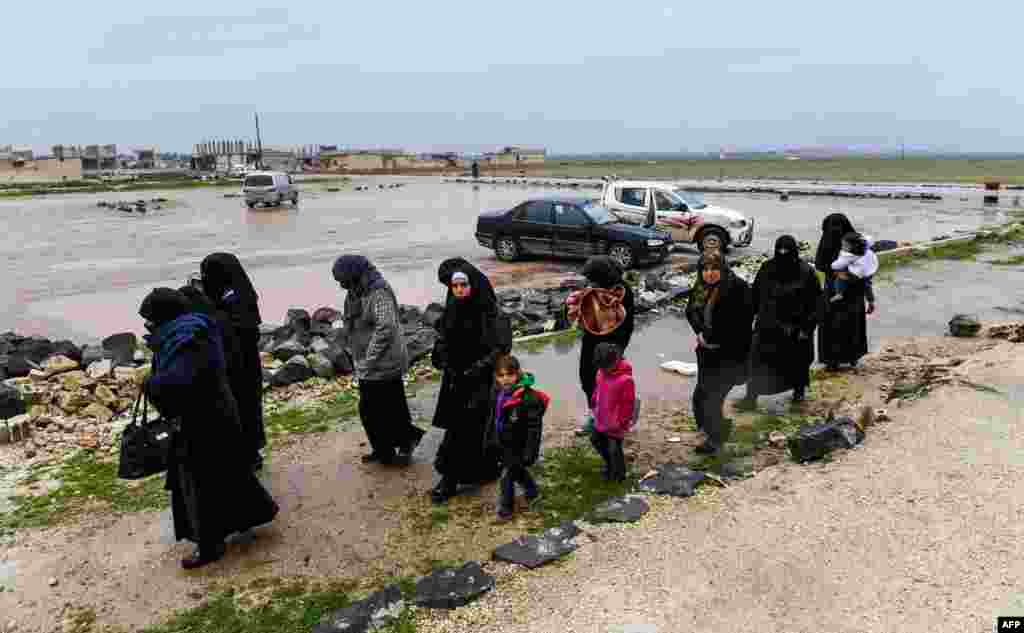 Syrian civilians cross from rebel-held areas in Idlib province into regime-held territories on through the Abu Duhur crossing.