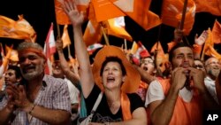 Supporters of Christian leader Michel Aoun hold Free Patriotic Movement and Lebanese flags, during a protest in downtown Beirut, Lebanon, Sept. 4, 2015. 