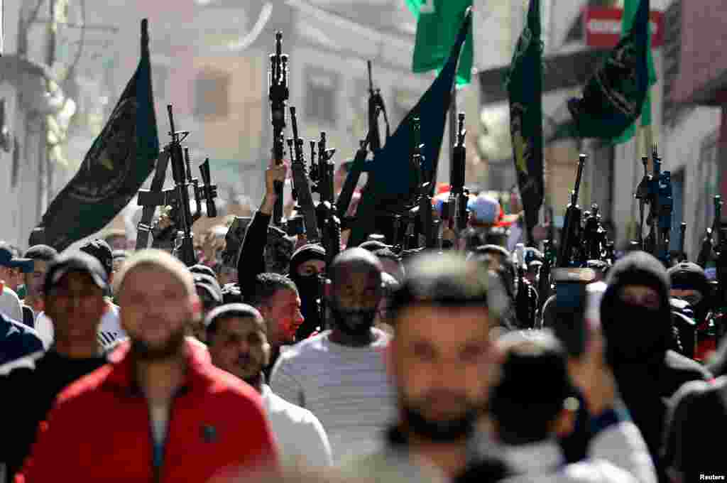 Mourners and militants take part in the funeral of Palestinian boy Mohamed Dadis, who the Palestinian health ministry said was killed by Israeli forces during clashes, in Nablus, in the Israeli occupied West Bank, Nov. 6, 2021.