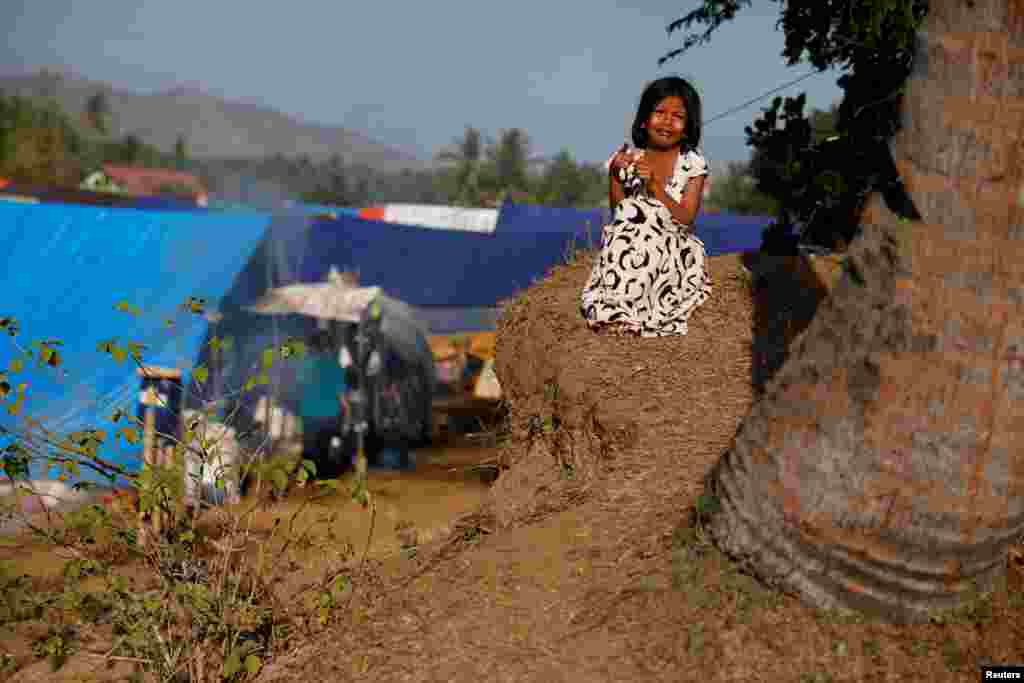 A girl cries as she waits for breakfast at a refugee camp after an earthquake hit on Sunday at Sigar Penjalin village in North Lombok, Indonesia.