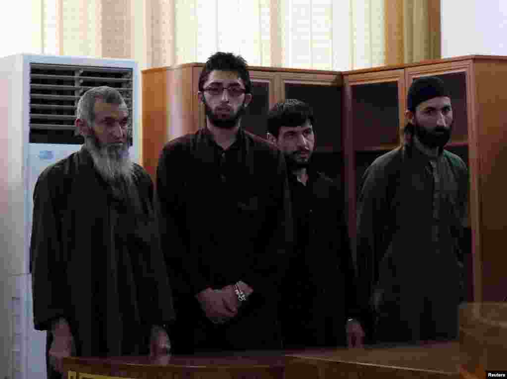 Four Afghan men look on in court during their trial in connection with the killing of a 27-year-old woman, in Kabul, Afghanistan May 6, 2015. An Afghan judge sentenced the four men to death on Wednesday for the mob killing of a 27-year-old woman accused of burning a Quran in Kabul, a case that sparked outrage and street protests in the city.