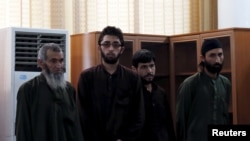 FILE - Four Afghan men look on in court during their trial in connection with the killing of a 27-year-old woman, in Kabul, Afghanistan May 6, 2015.