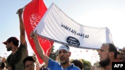 FILE: Ennahda partysupporters outside the Constituent Assembly on July 28, 2013 in Tunis. Opposition leader Mohamed Brahmi was shot dead outside his home on Friday with the same weapon used to kill fellow opposition politician Chokri Belaid authorities said.