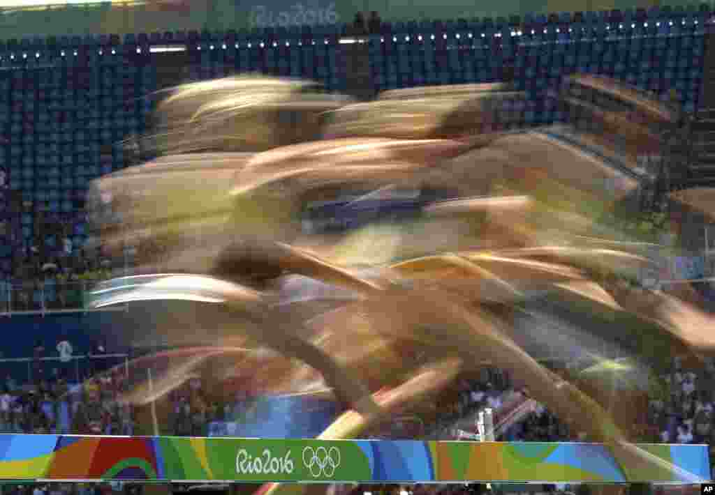 Athletes compete in the women's 3000-meter steeplechase final during the athletics competitions at the Olympic stadium in Rio de Janeiro, Brazil