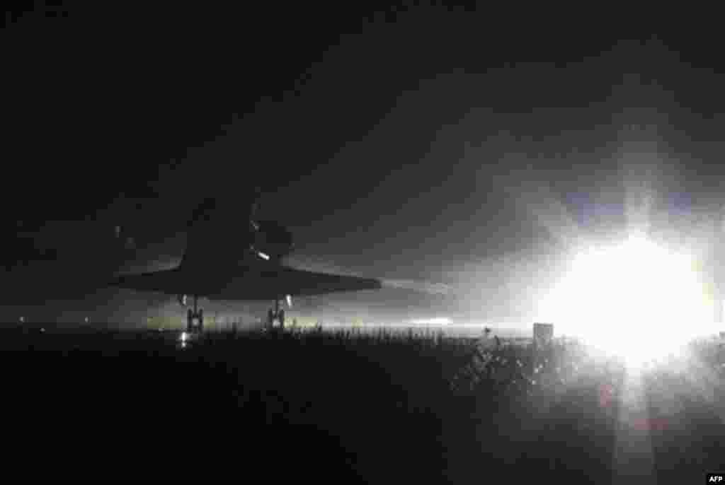 Space Shuttle Atlantis lands at the Kennedy Space Center at Cape Canaveral, Fla. Thursday, July 21, 2011. The landing of Atlantis marks the end of NASA's 30 year space shuttle program. (AP Photo/Terry Renna)