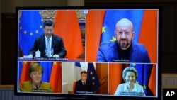 FILE - A screen displays live Chinese President Xi Jinping, top left, European Council President Charles Michel, top right, European Commission President Ursula von der Leyen, bottom right, French President Emmanuel Macron, bottom center, and German Chanc
