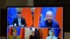 FILE - A screen displays live Chinese President Xi Jinping, top left, European Council President Charles Michel, top right, European Commission President Ursula von der Leyen, bottom right, French President Emmanuel Macron, bottom center, and German Chancellor Angela Merkel.