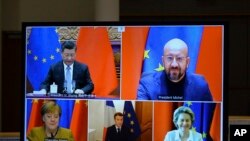 FILE - A screen displays live Chinese President Xi Jinping, top left, European Council President Charles Michel, top right, European Commission President Ursula von der Leyen, bottom right, French President Emmanuel Macron, bottom center, and German Chancellor Angela Merkel.