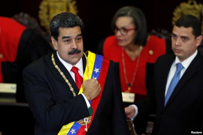 Venezuela's President Nicolas Maduro gestures during a ceremony to mark the opening of the judicial year at the Supreme Court of Justice (TSJ), in Caracas, Venezuela, Jan. 24, 2019.