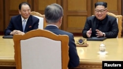 Kim Yong Chol, left, sits next to North Korean leader Kim Jong Un during talks with South Korean President Moon Jae-in during their summit at the truce village of Panmunjom, North Korea, May 26, 2018.