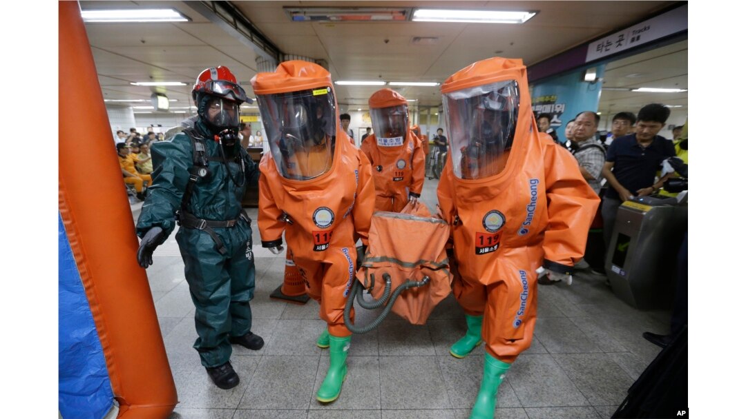 South Korean firefighters wearing protective gears move during an anti-terror drill as part of Ulchi Freedom Guardian exercise, at Yoido Subway Station in Seoul, South Korea, Aug. 23, 2016.