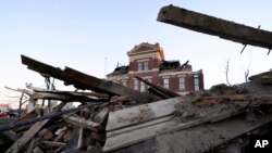 Debris is piled around the the damaged Graves County Courthouse on Dec. 12, 2021, in Mayfield, Ky. 