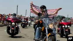 FILE - Participants in the annual Rolling Thunder motorcycle rally ride past Arlington Memorial Bridge during the parade ahead of Memorial Day in Washington, May 24, 2015.