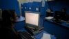 FILE - People use an internet cafe in Pakistan, March 7, 2012. While internet and social media services across Pakistan are regularly disrupted to prevent dissent, Pakistan said July 30, 2024, that engineers have created a messaging app for secure communication among officials.