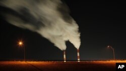 FILE - In this Jan. 19, 2012 file photo, smoke rises in this time exposure image from the stacks of the La Cygne Generating Station coal-fired power plant in La Cygne, Kansas.