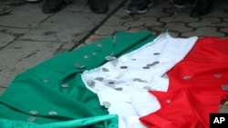 Cờ Hungary bị bỏ dưới đất trong 1 cuộc biểu tình tại Lãnh sự quán Hungary ở Yerevan, Armenia, 1/9/2012. Các đồng tiền trên lá cờ tượng trưng cho việc Hungary đã được trả tiền để thả binh sĩ Azerbaijan